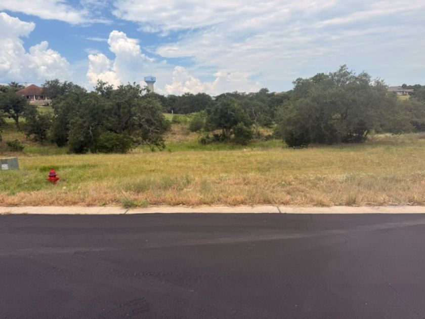 W5009 Up There Road Horseshoe Bay, TX 78657 - Photo 2 of 6 A spacious, buildable lot awaits your vision, featuring mature trees and a gently sloping terrain.