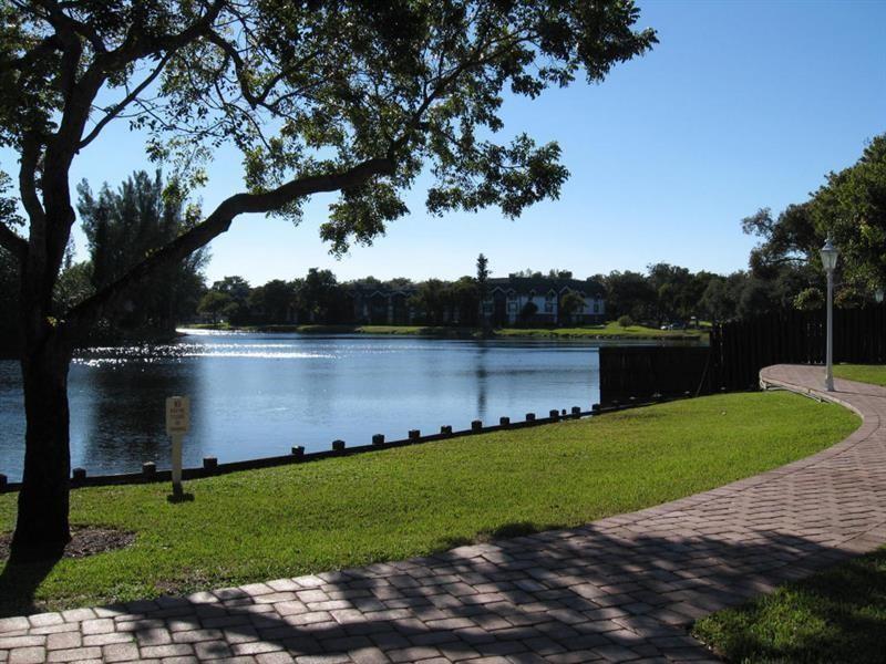3650 Inverrary Drive, Unit 3Q Lauderhill, FL 33319 - Photo 13 of 16 a view of a lake with a garden