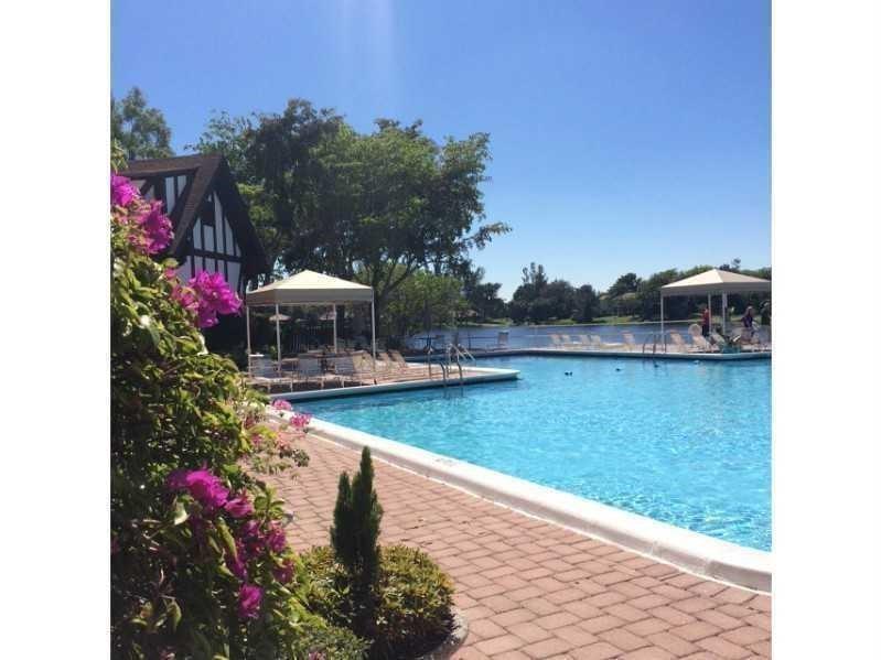 3650 Inverrary Drive, Unit 3Q Lauderhill, FL 33319 - Photo 15 of 16 a view of a house with a yard and sitting area