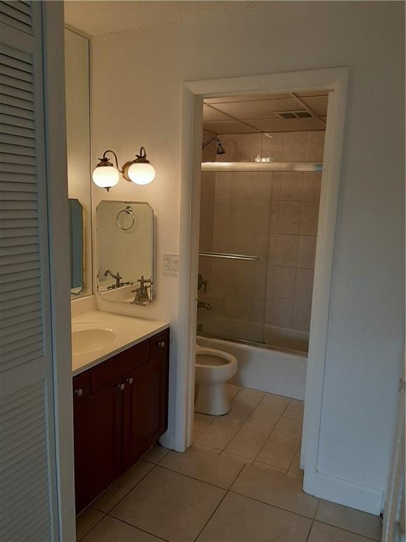 3650 Inverrary Drive, Unit 3Q Lauderhill, FL 33319 - Photo 4 of 16 a bathroom with a toilet sink and mirror