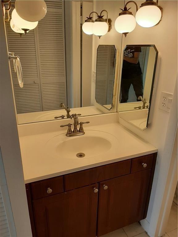 3650 Inverrary Drive, Unit 3Q Lauderhill, FL 33319 - Photo 5 of 16 a bathroom with a sink and a mirror