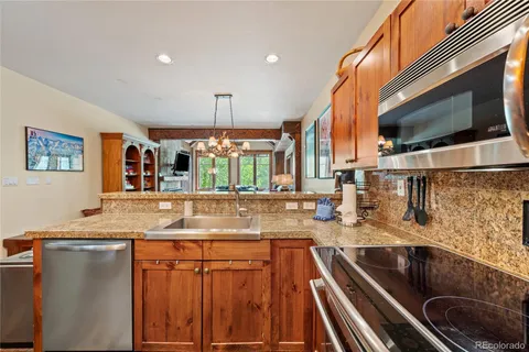 a kitchen with stainless steel appliances granite countertop a sink and a microwave