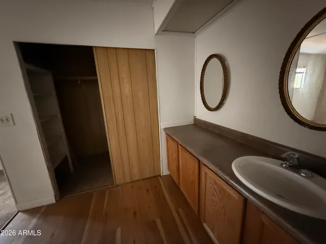 a view of a closet with wooden floor