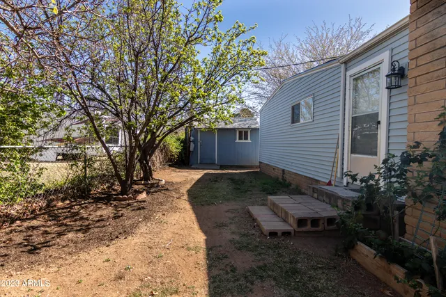a view of a backyard with sitting area