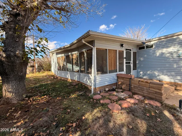 a view of a house with yard and wooden fence