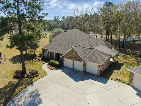 a view of a house with a yard and sitting area
