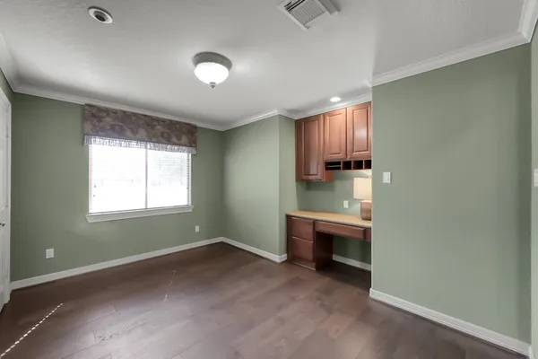 an empty room with a fireplace and window