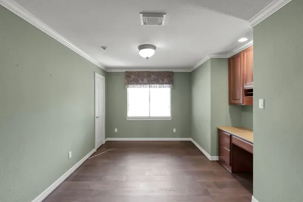 an empty room with a fireplace and windows