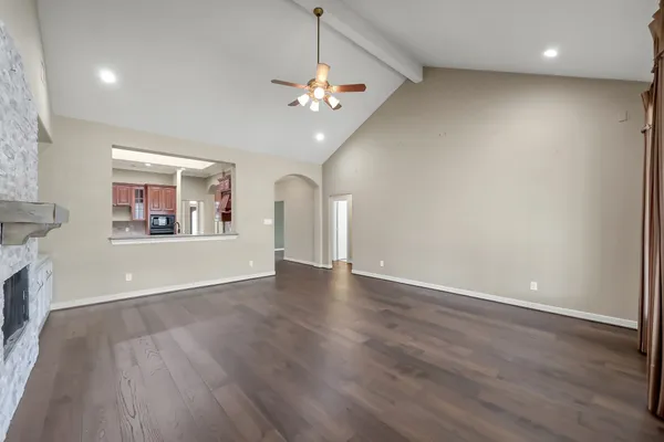 a view of a livingroom with a ceiling fan window and wooden floor