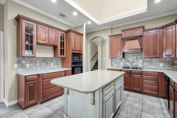 a kitchen that has a sink and a stove in it