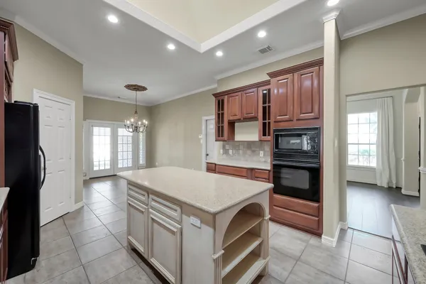a kitchen that has a lot of cabinets in it and a refrigerator
