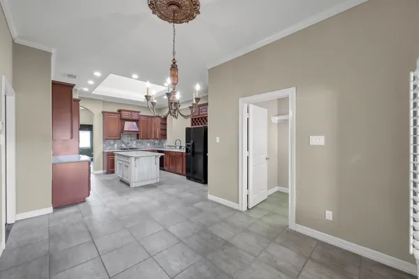 a open kitchen with cabinets and stainless steel appliances