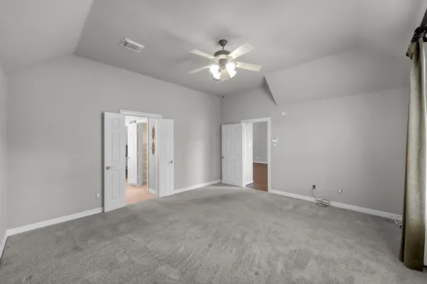 a view of an empty room with a ceiling fan