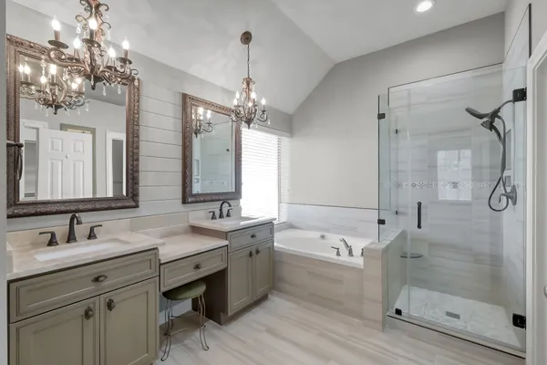 a bathroom with a double vanity sink mirror double and shower
