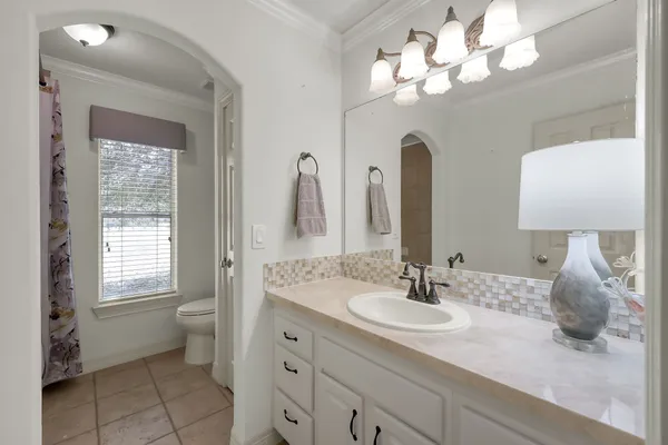 a bathroom with a sink a light fixture and a mirror