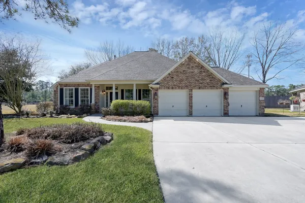 a front view of house with a garden