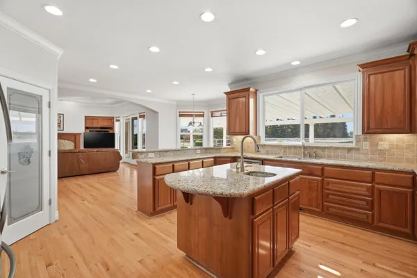 a kitchen with stainless steel appliances granite countertop a sink and cabinets