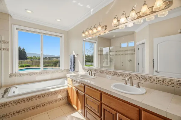 a bathroom with a tub shower and window
