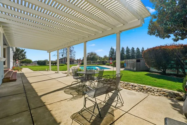 a view of an house with backyard space and balcony