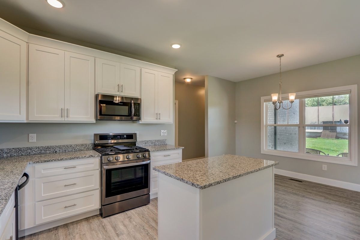 1179 Payne Road Portland, TN 37148 - Photo 9 of 34 a kitchen with granite countertop white cabinets and appliances