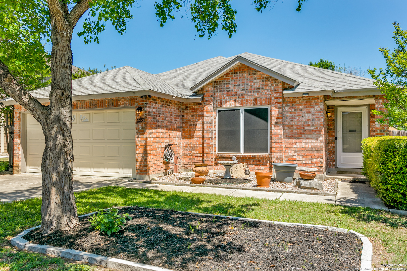 a front view of a house with garden