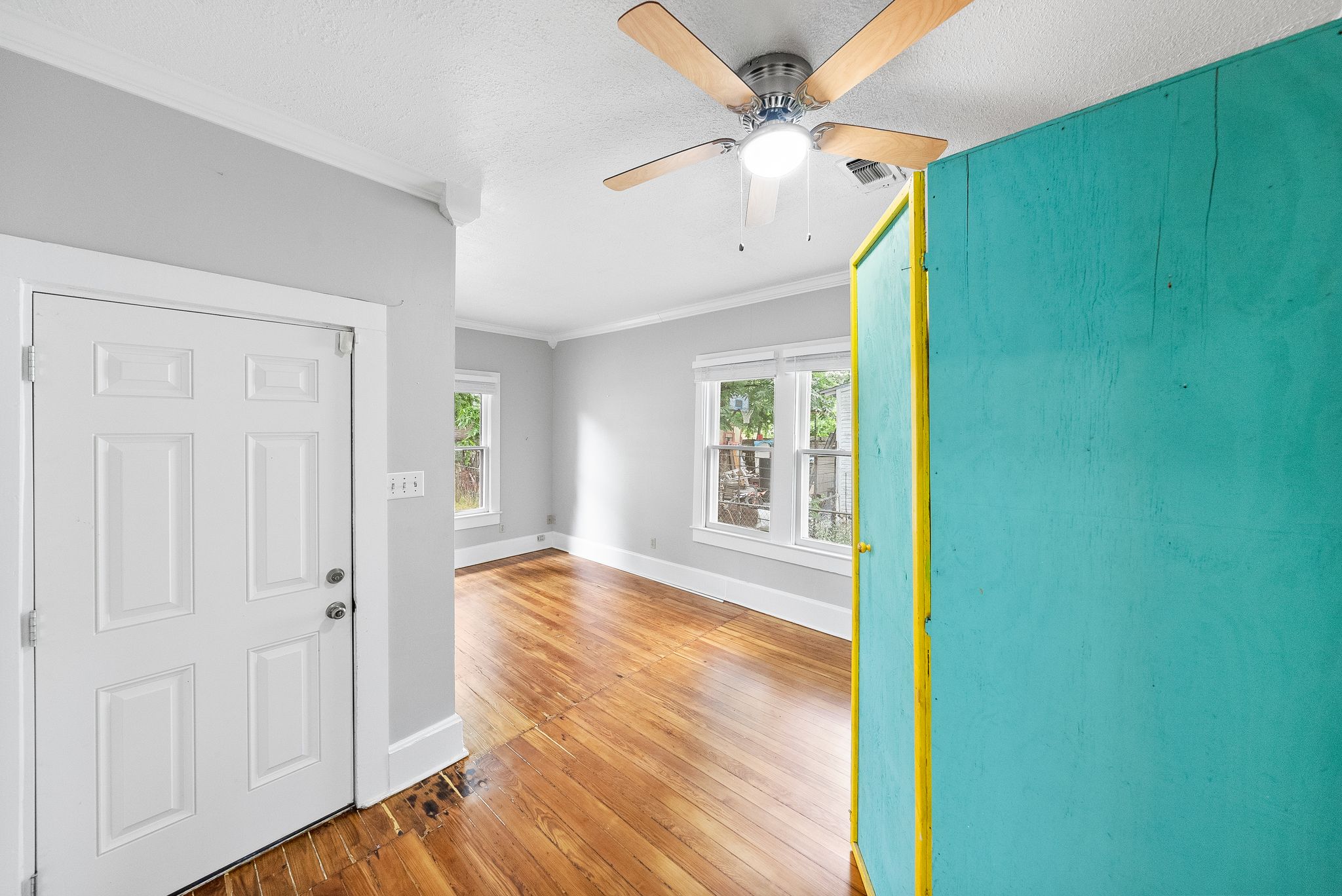 2032 East Cesar Chavez Street Austin, TX 78702 - Photo 11 of 25 a view of an empty room with wooden floor and a window