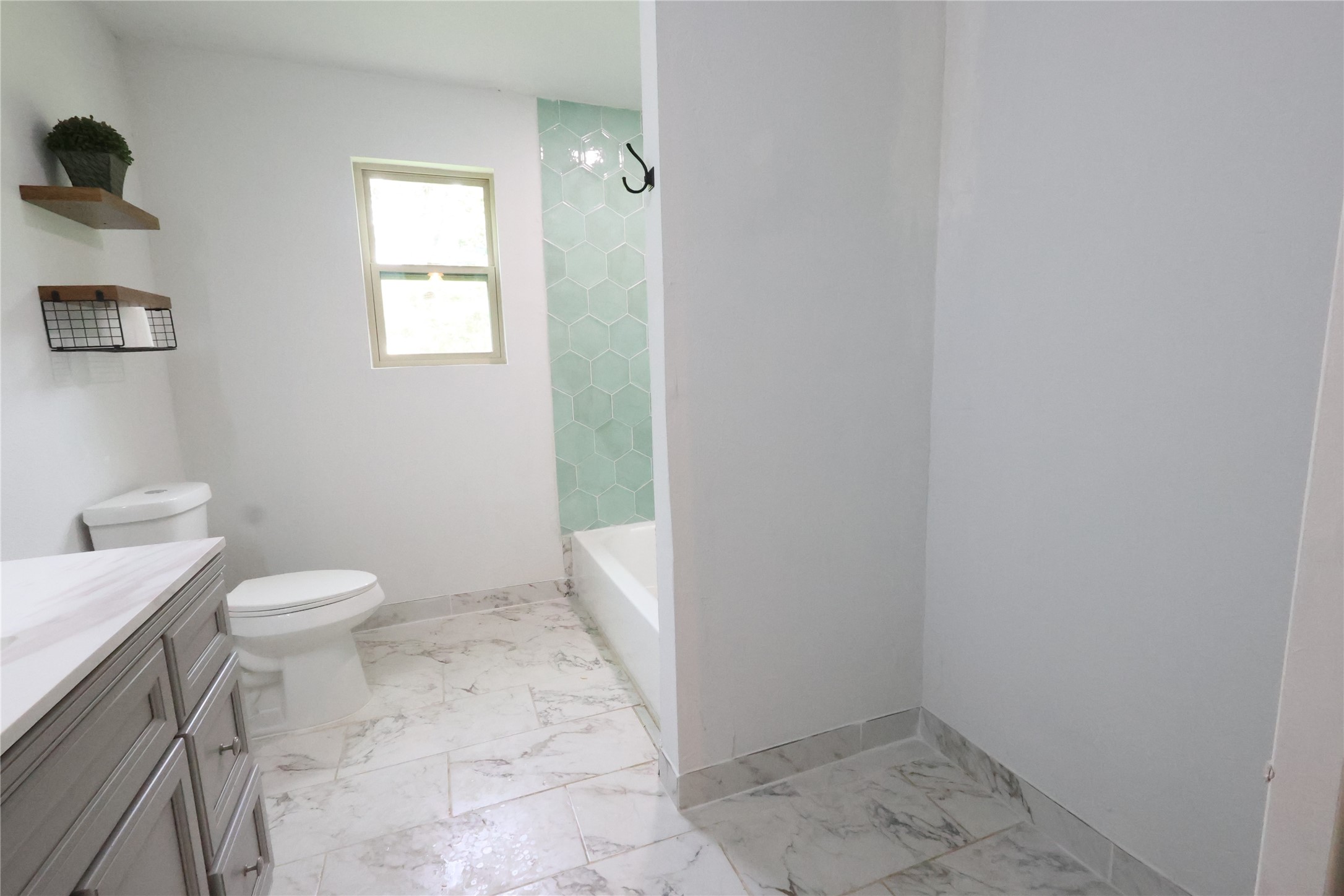 21805 Baptist Encampment Road New Caney, TX 77357 - Photo 24 of 33 Renovated with shower/tub combination, and a space for more cabinets of your choice.