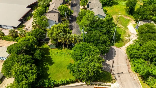 an aerial view of residential house with green space