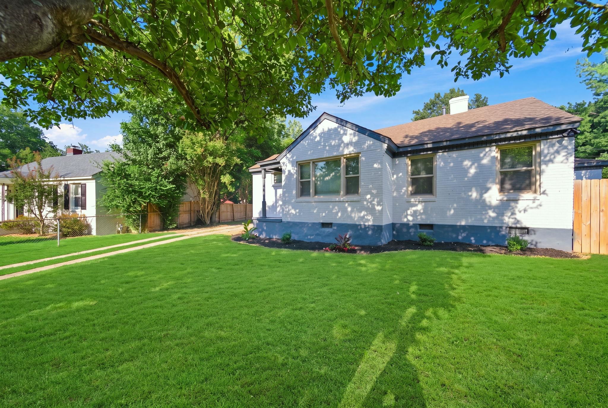 458 Gerald Road Memphis, TN 38122 - Photo 2 of 37 White exterior with dark trim, featuring a gable roof and multiple windows