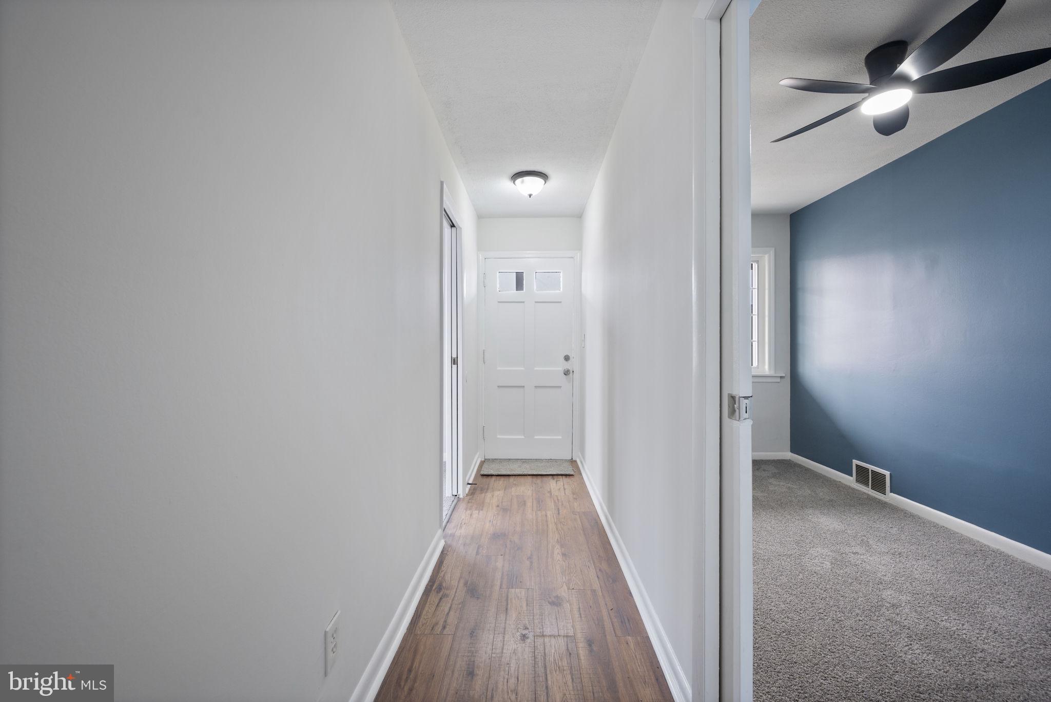 417 Meadow Road Baltimore, MD 21206 - Photo 15 of 47 a view of a hallway with wooden floor and closet