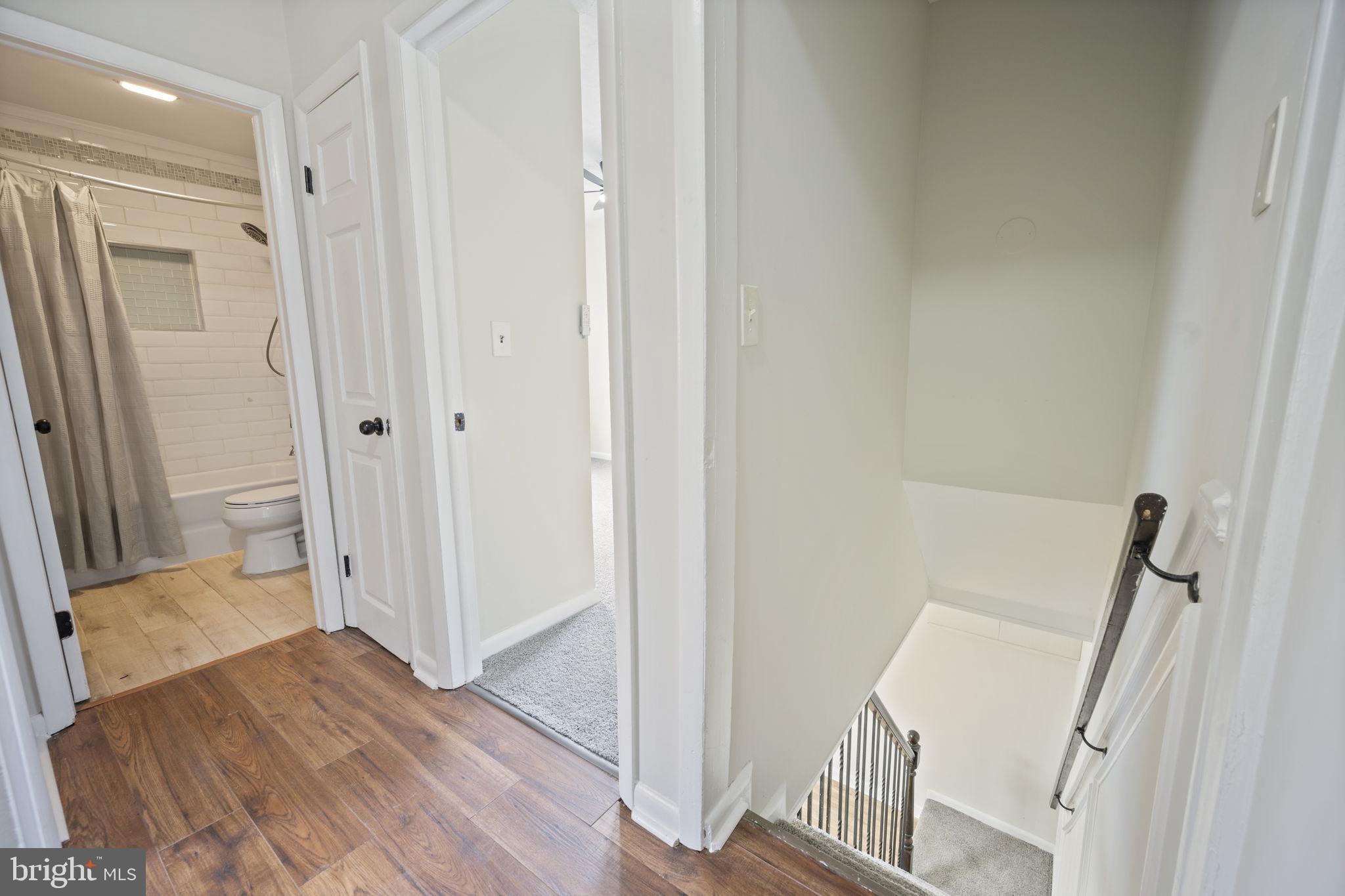 417 Meadow Road Baltimore, MD 21206 - Photo 16 of 47 a view of a hallway with wooden floor and staircase
