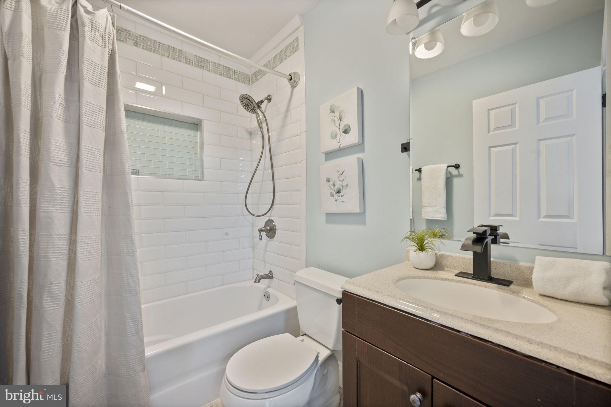 417 Meadow Road Baltimore, MD 21206 - Photo 17 of 47 a bathroom with a sink a toilet and shower