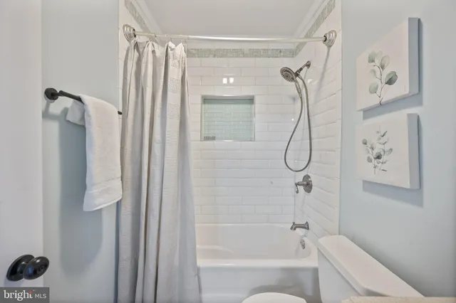 a bathroom with a shower a bath tub and a shower