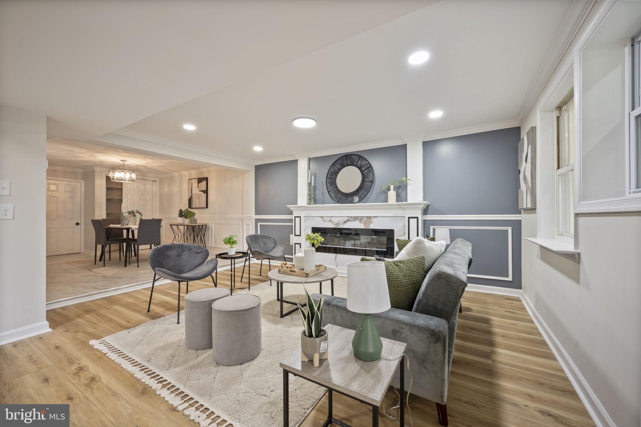 417 Meadow Road Baltimore, MD 21206 - Photo 2 of 47 a living room with furniture a fireplace and kitchen view