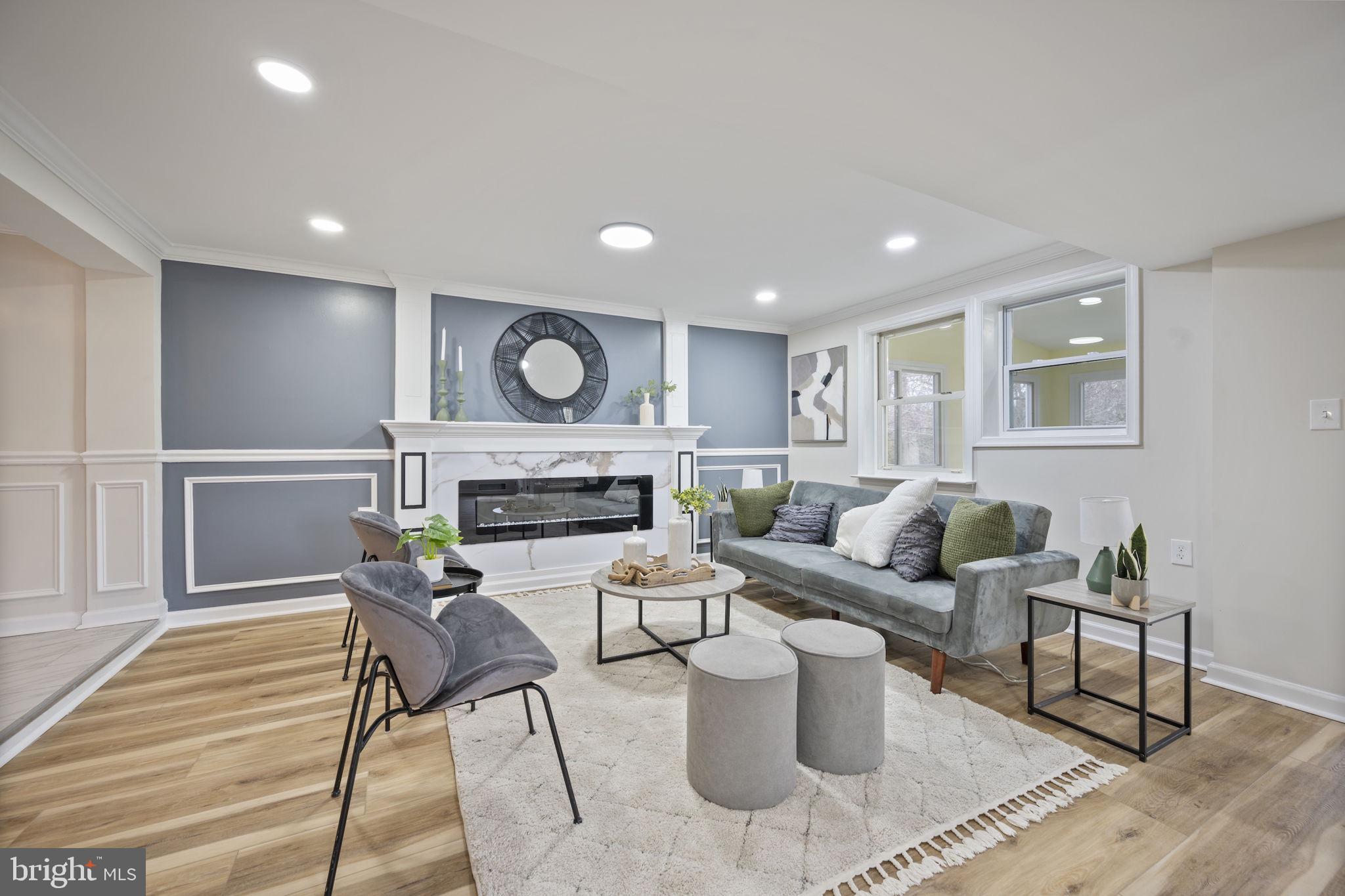 417 Meadow Road Baltimore, MD 21206 - Photo 22 of 47 a living room with furniture a fireplace and a table