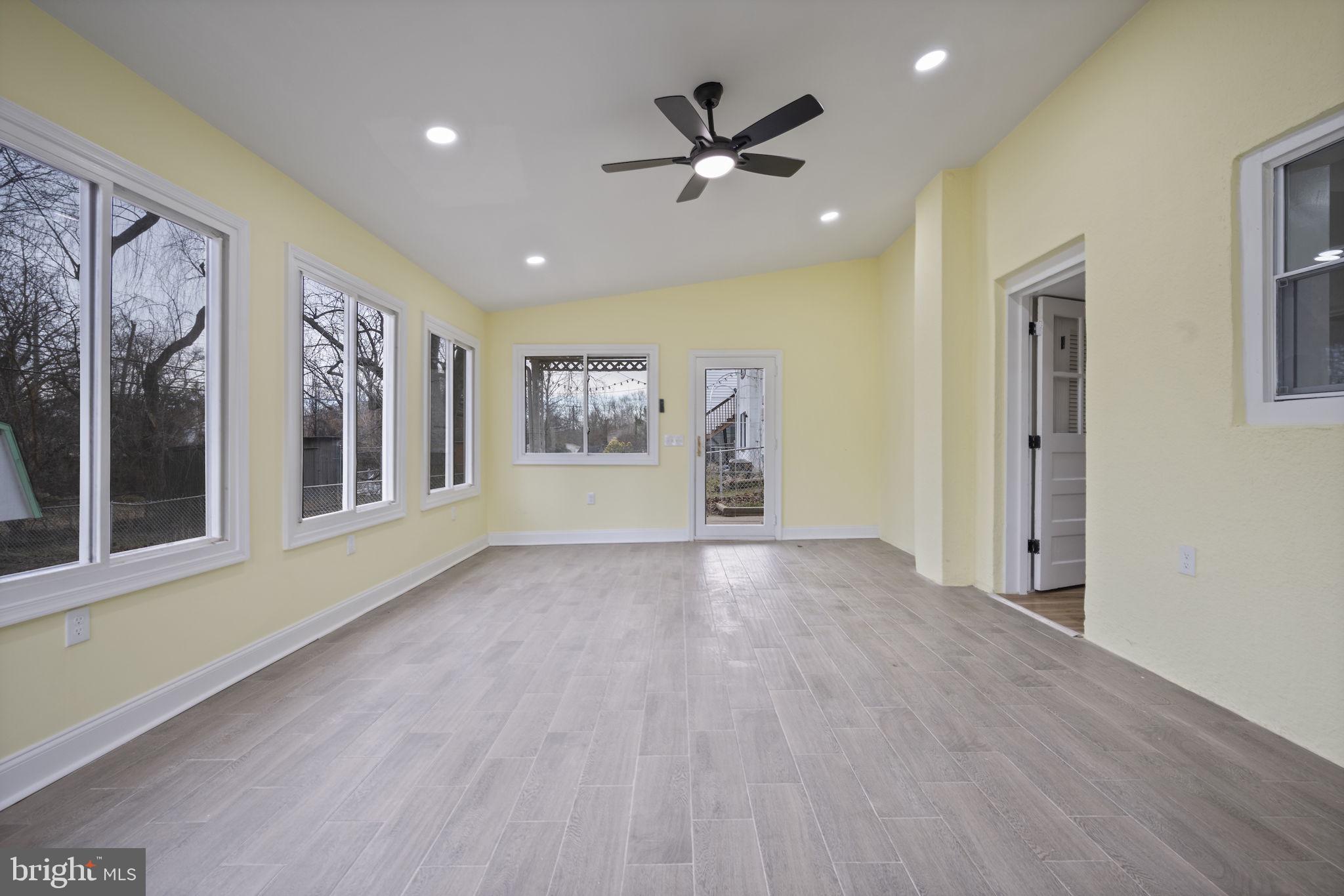 417 Meadow Road Baltimore, MD 21206 - Photo 26 of 47 a view of an empty room with a window and wooden floor