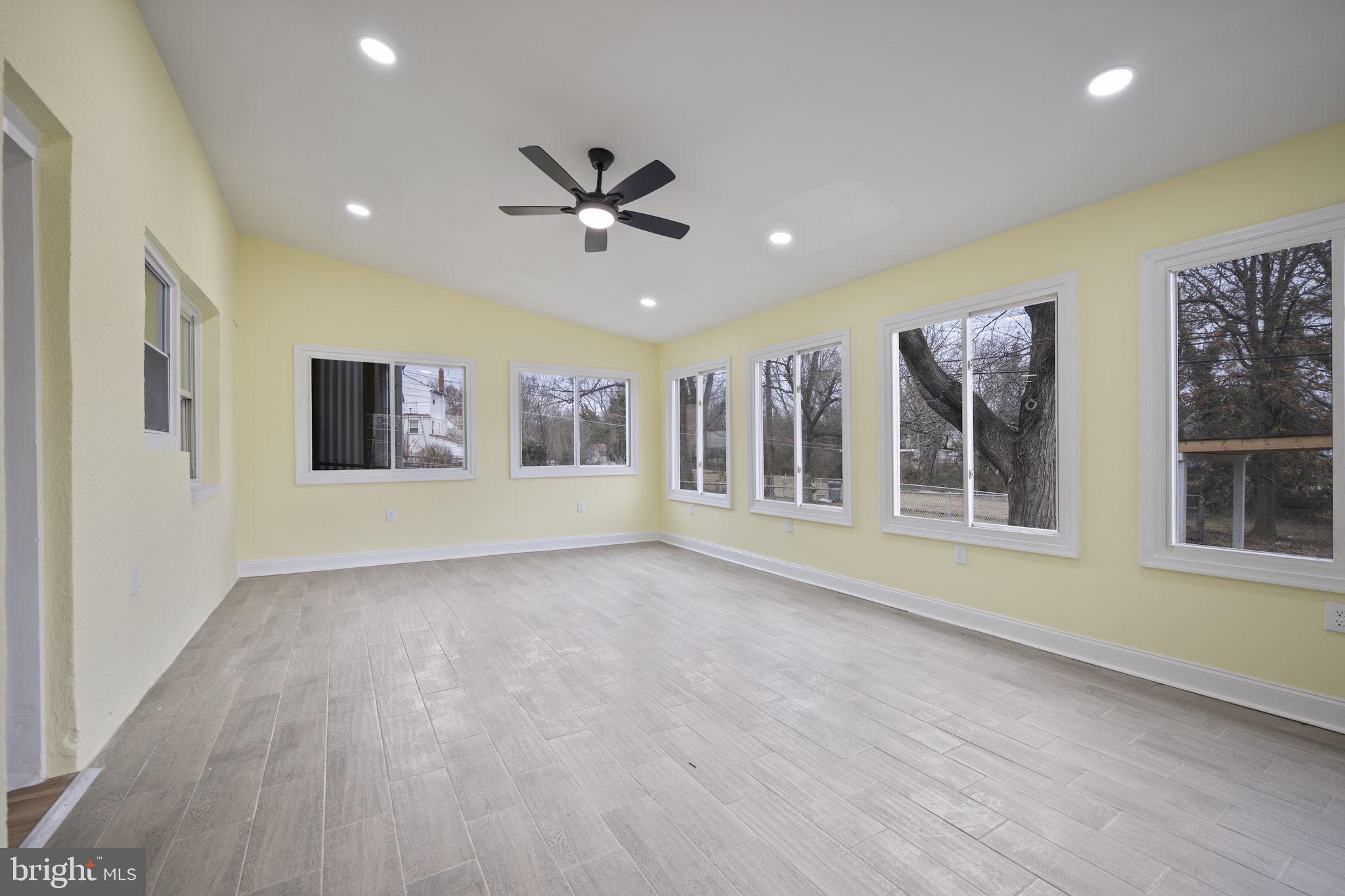 417 Meadow Road Baltimore, MD 21206 - Photo 28 of 47 a view of an empty room with a window and wooden floor