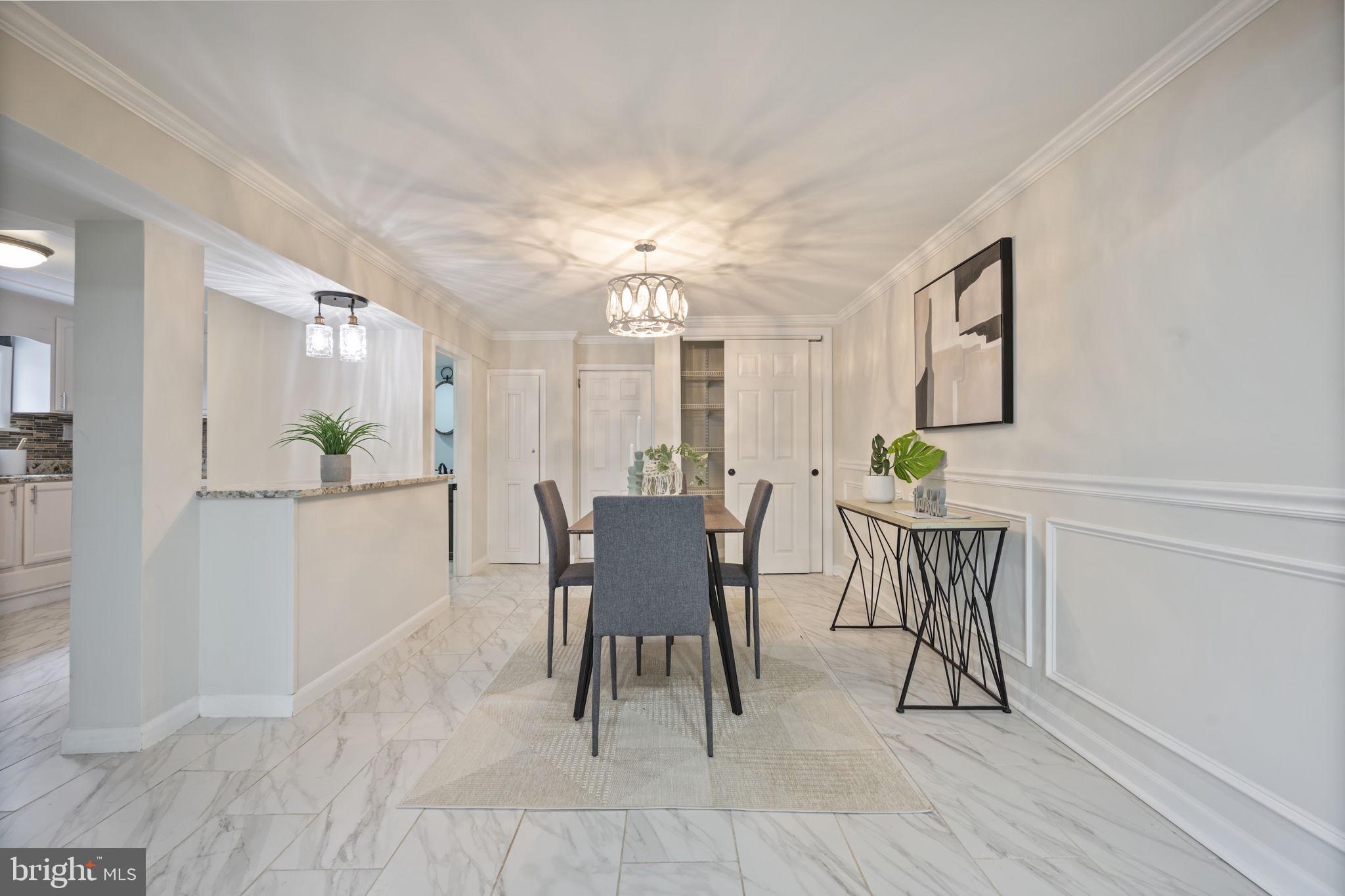 417 Meadow Road Baltimore, MD 21206 - Photo 30 of 47 a view of a dining room with furniture and chandelier