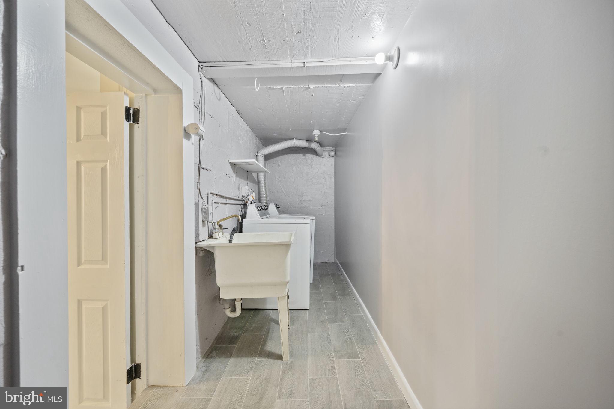 417 Meadow Road Baltimore, MD 21206 - Photo 41 of 47 a bathroom with a sink mirror and toilet