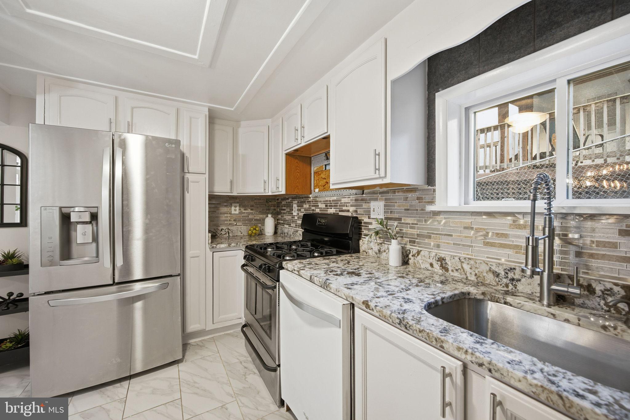 417 Meadow Road Baltimore, MD 21206 - Photo 42 of 47 a kitchen with a refrigerator stove and sink