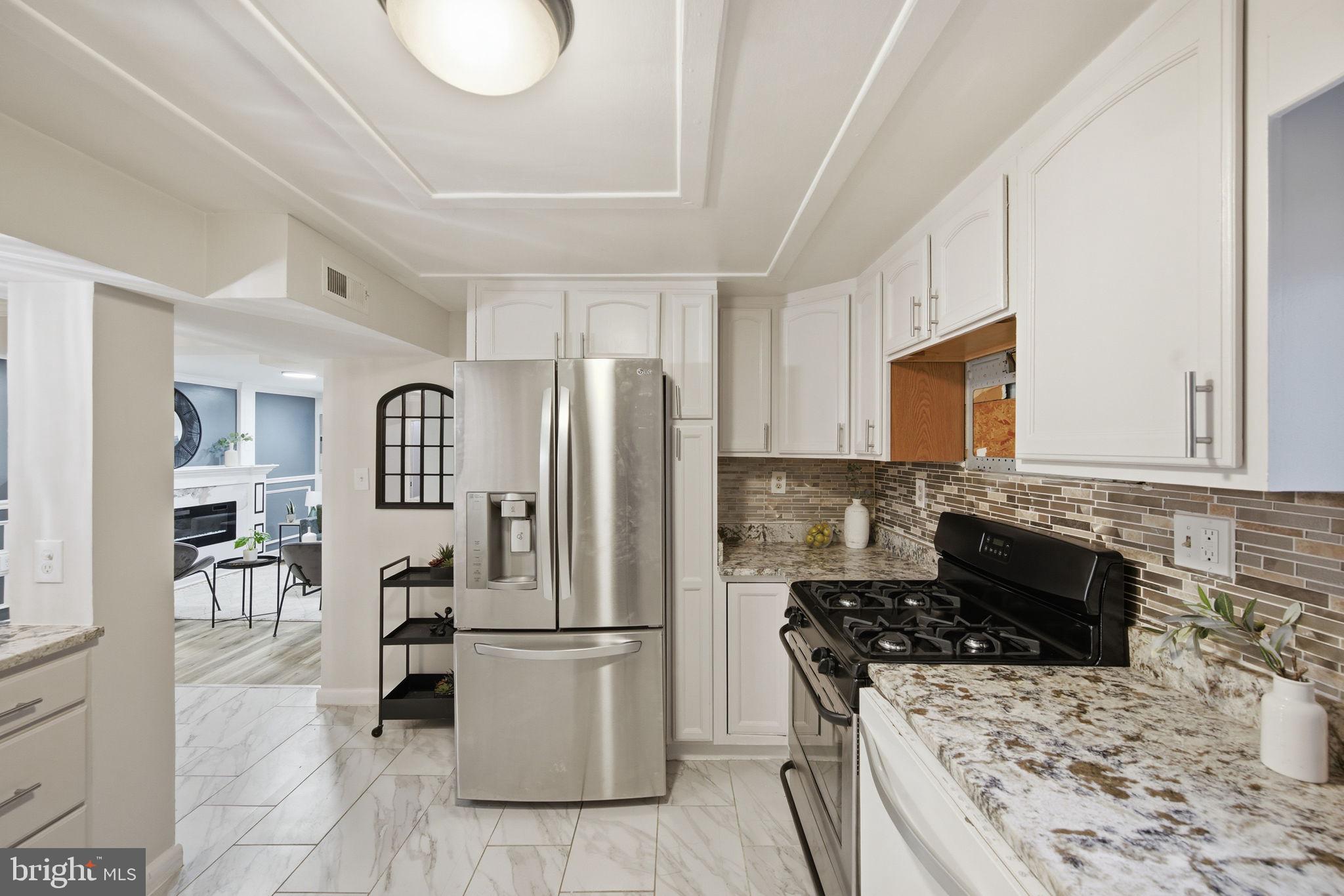 417 Meadow Road Baltimore, MD 21206 - Photo 43 of 47 a kitchen with a stove a refrigerator and chairs