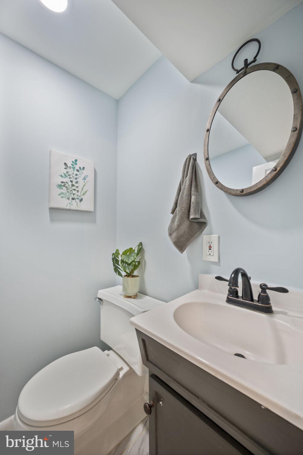 417 Meadow Road Baltimore, MD 21206 - Photo 44 of 47 a bathroom with a toilet a sink and mirror