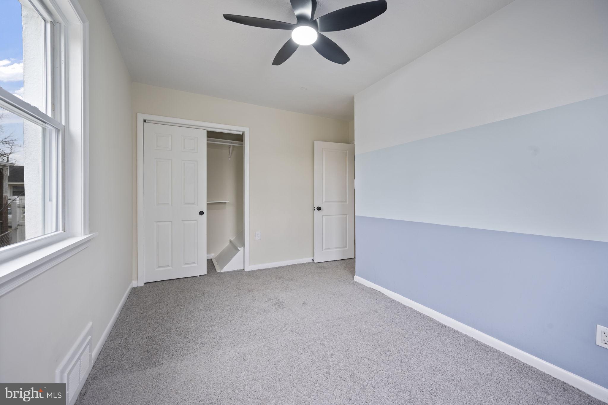 417 Meadow Road Baltimore, MD 21206 - Photo 9 of 47 an empty room with chandelier fan