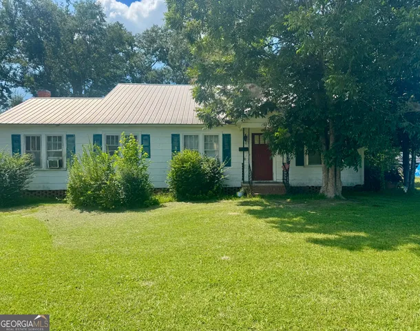 a front view of house with yard and green space