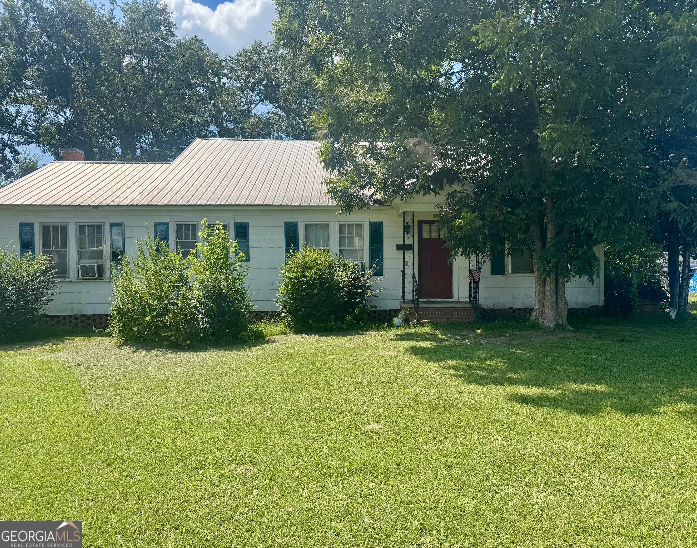 a front view of house with yard and green space