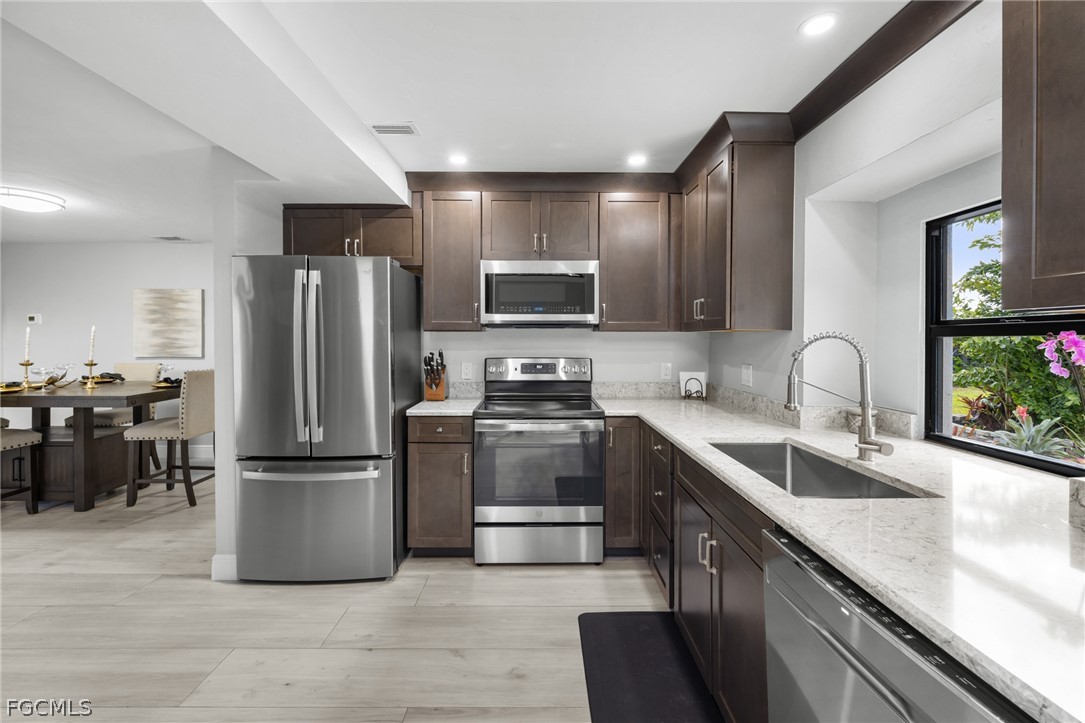 12991 Iona Road Fort Myers, FL 33908 - Photo 12 of 43 a kitchen with a refrigerator sink and microwave
