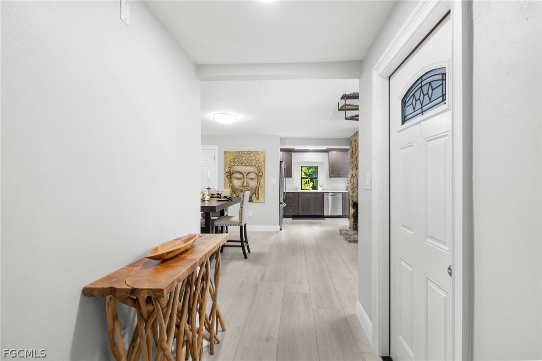 12991 Iona Road Fort Myers, FL 33908 - Photo 14 of 43 a view of a hallway with workspace and living room
