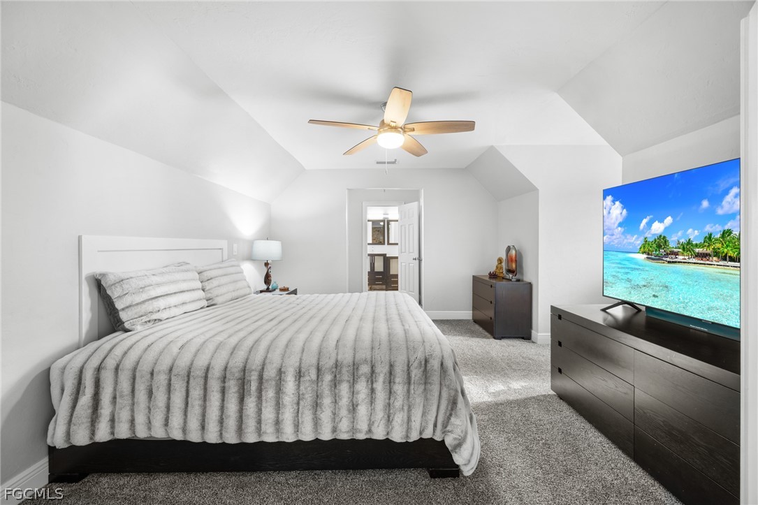 12991 Iona Road Fort Myers, FL 33908 - Photo 17 of 43 a bedroom with a large bed and a large window