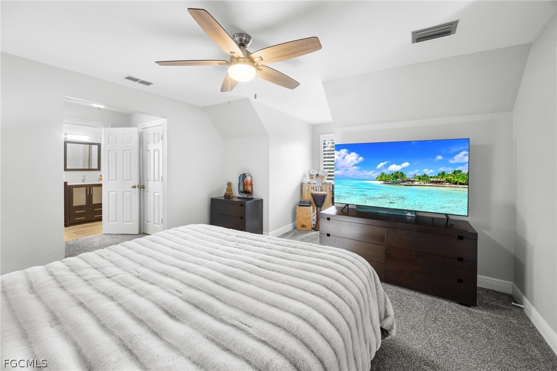 12991 Iona Road Fort Myers, FL 33908 - Photo 18 of 43 a bedroom with a bed and a flat screen tv
