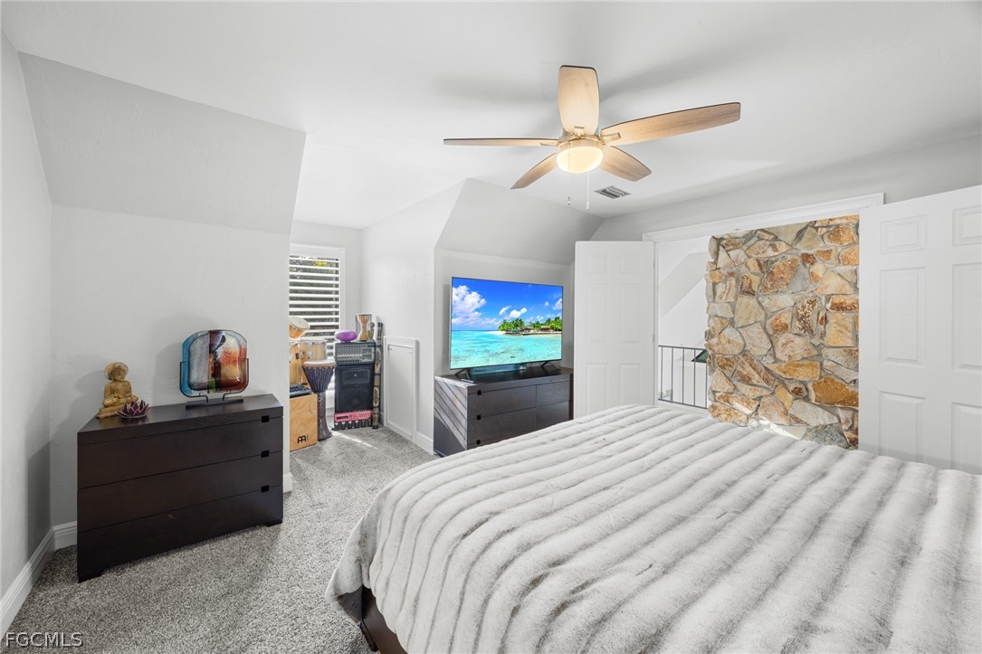 12991 Iona Road Fort Myers, FL 33908 - Photo 19 of 43 a bedroom with a bed and a chandelier